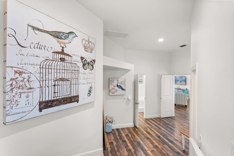 Vibrant artwork and rich wood floors welcome you to your beachside retreat!