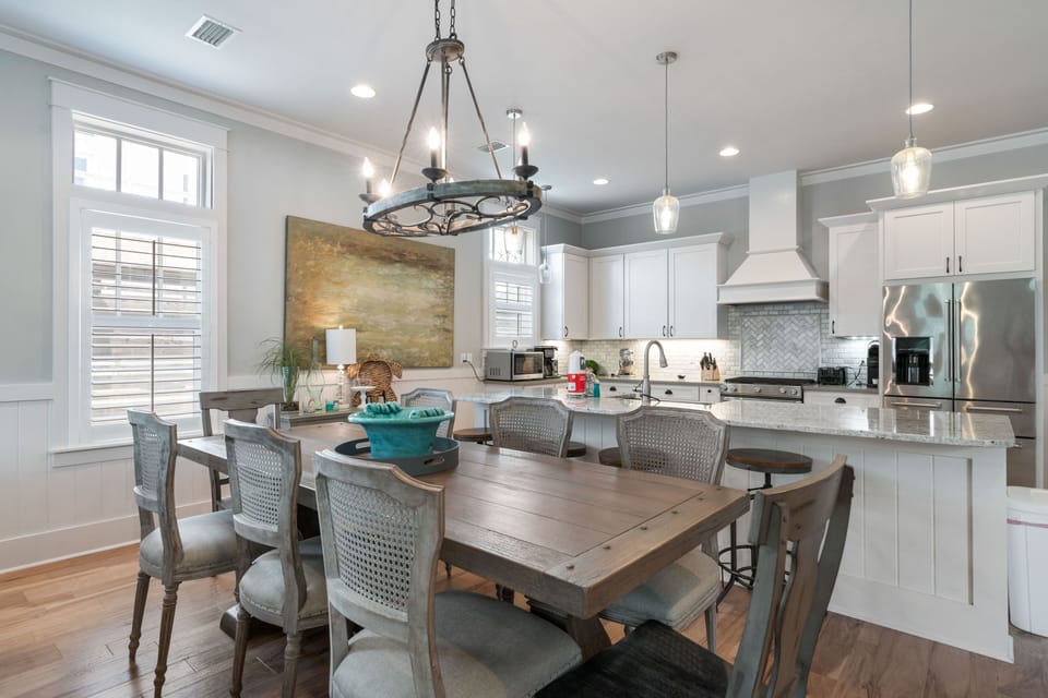 Beautiful dining space with seating for a group, accented by coastal décor.