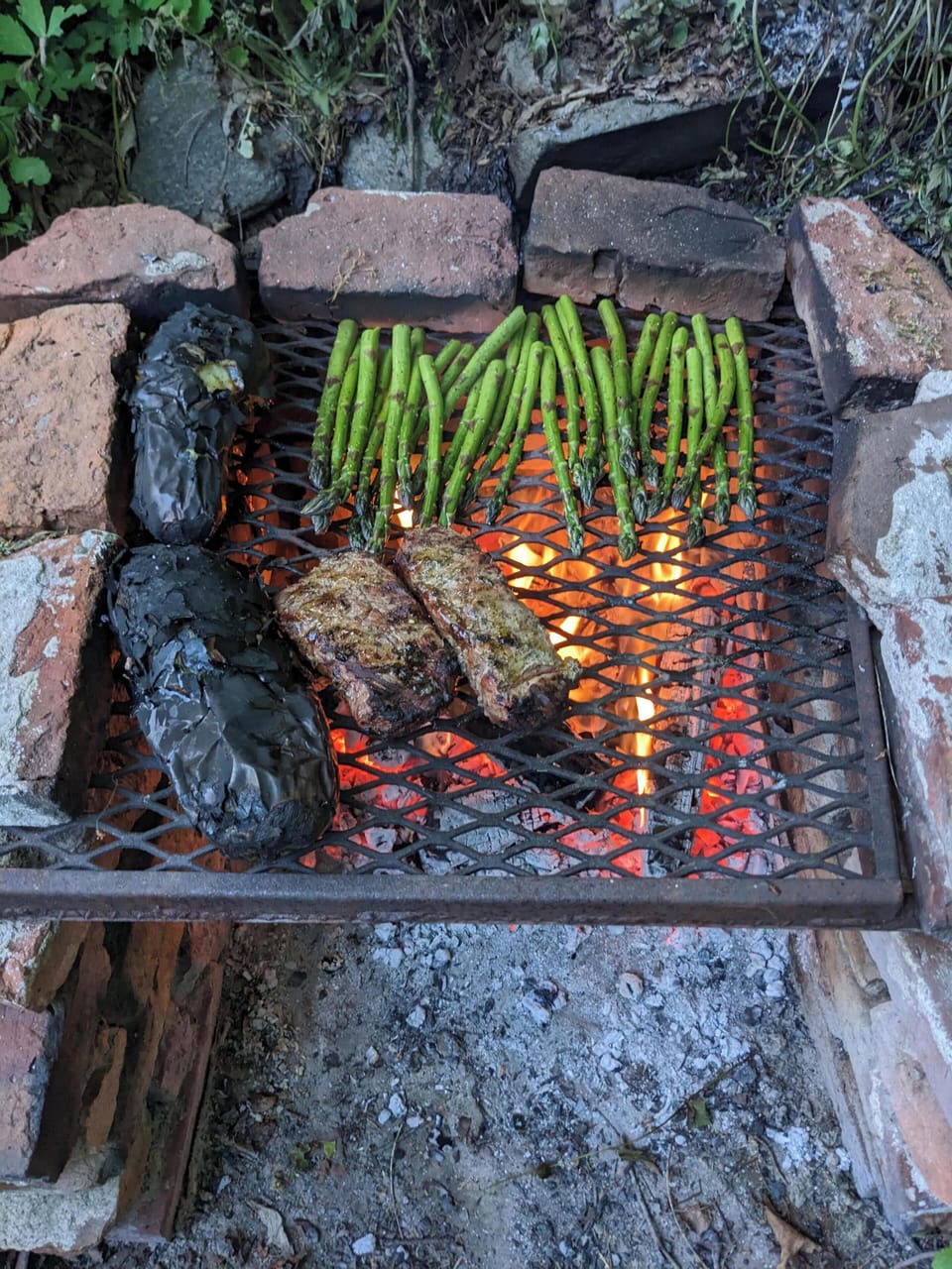 Grill pit for wood-fired cooking.