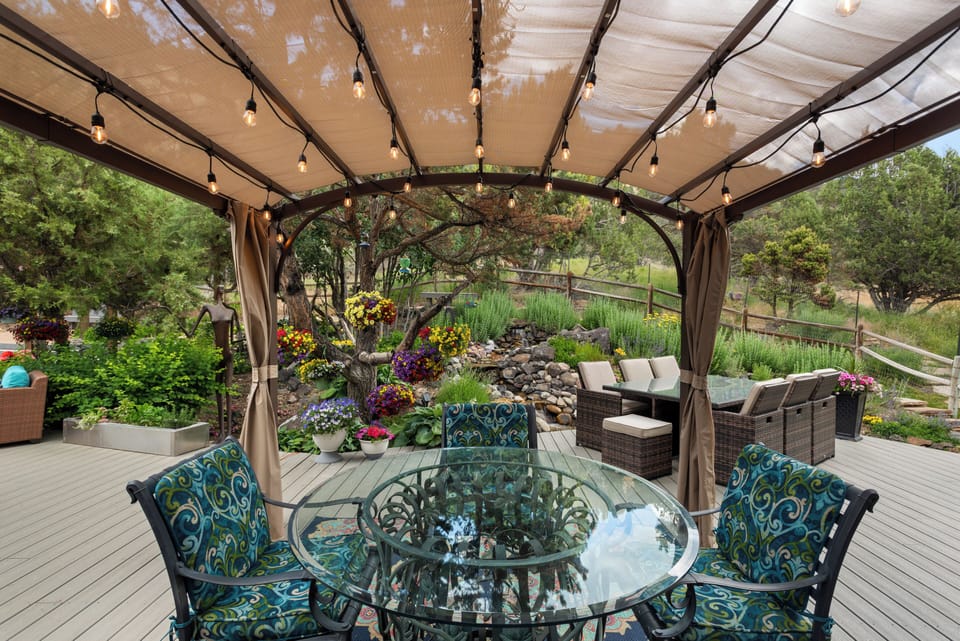 One of our favorite spaces — outdoor dining with flowers and water feature