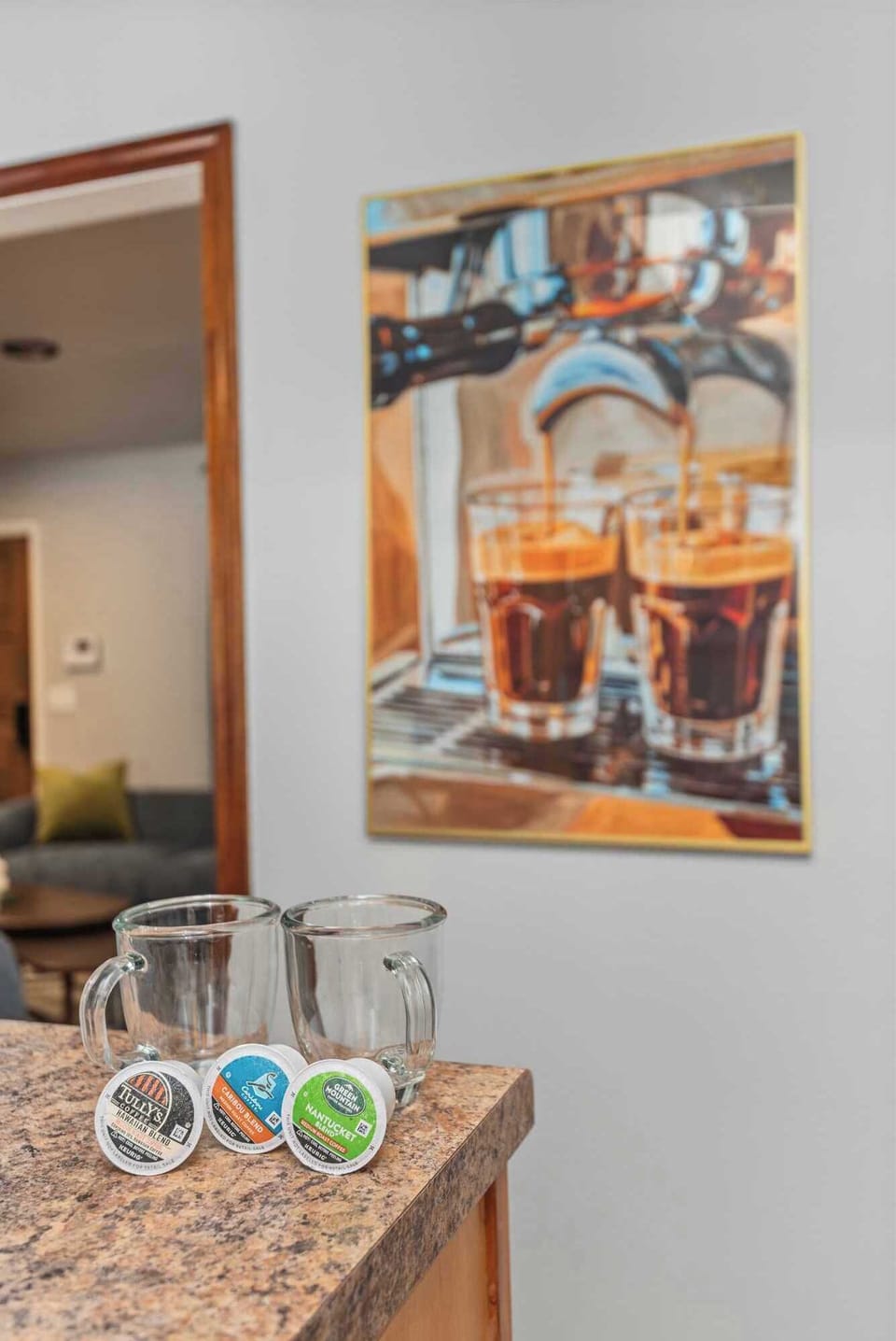 Coffee bar setup with mugs and artwork—perfect for morning brews in the kitchen area