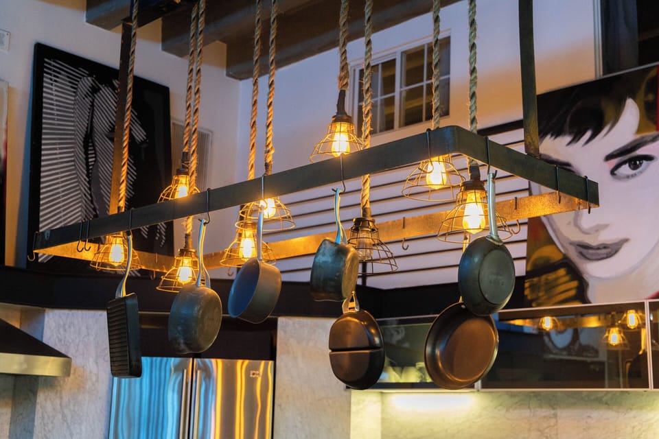 Hanging pot rack and diverse artwork.