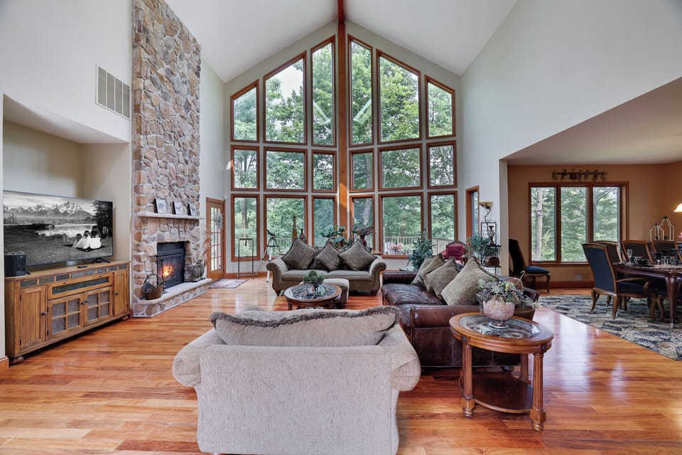 Wall of windows, cozy fire, and vaulted ceilings—this great room is the heart of the home and the perfect gathering space for your group getaway.