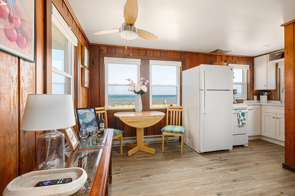 Open kitchen & dining area w/ lake views that make every meal feel special.