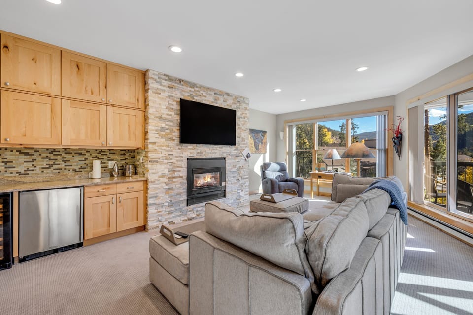 Living room has extra seating by the windows plus fireplace and TV to cozy up to!