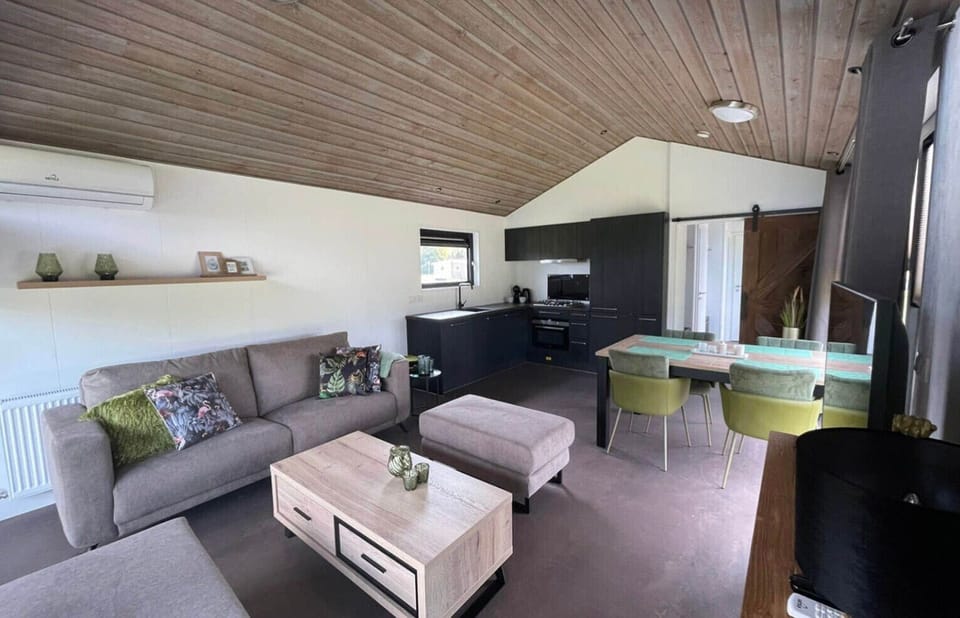 Living room, dining table, and kitchen at Vakantiepark de Zeeuwse Parel - de Parel