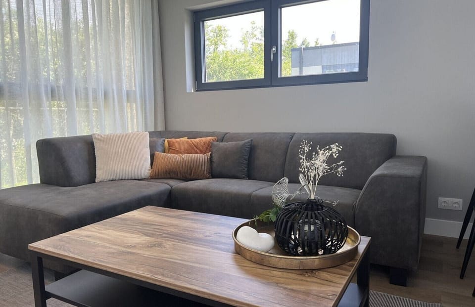 Living room with sofa at Vakantiepark de Zeeuwse Parel - de Zeebries