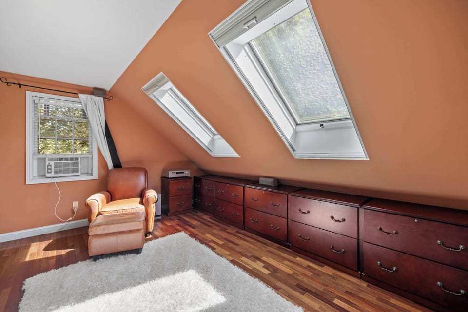 Primary suite with skylights and built-in storage, filled with natural light