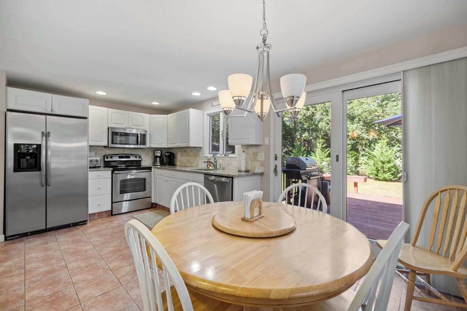 Dining area with natural light and sliding doors leading to the back deck