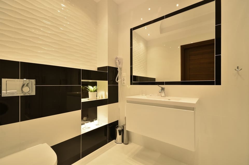 Practically furnished, modern bathroom with toilet, shower and sink.
