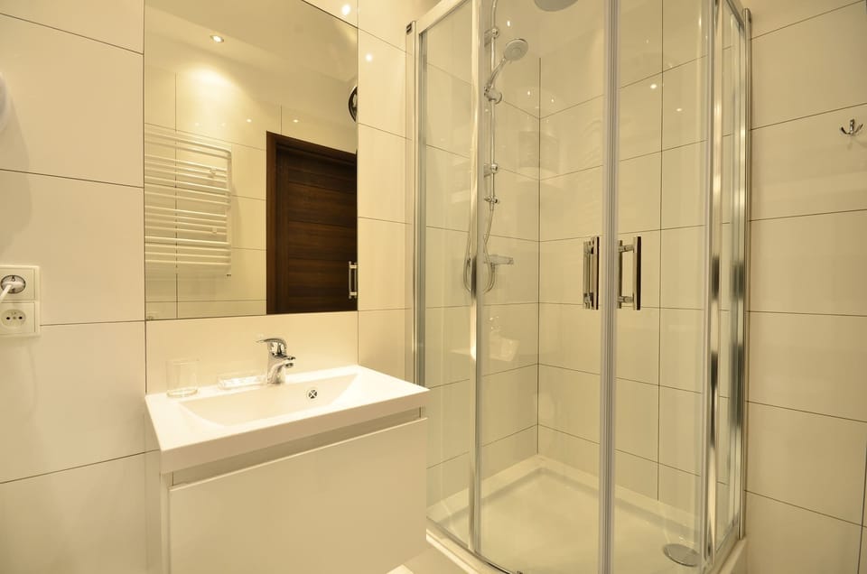 The bathroom was decorated in an aesthetically pleasing and functional manner. There are white tiles on the walls.