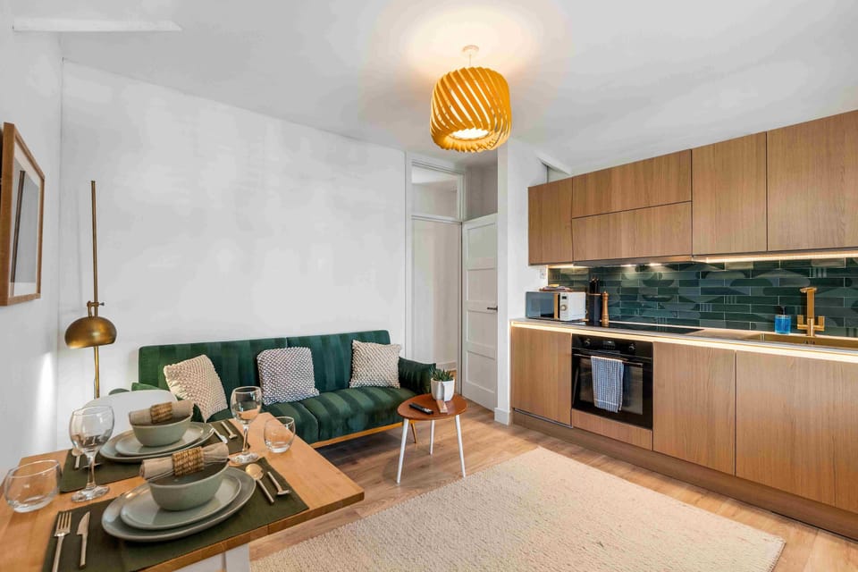 Bright and airy living room with large windows, stylish decor and a comfortable sofa perfect for relaxing.