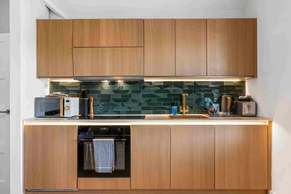 Sleek, fully equipped kitchen with contemporary fittings, light cabinetry, and ample workspace for cooking.