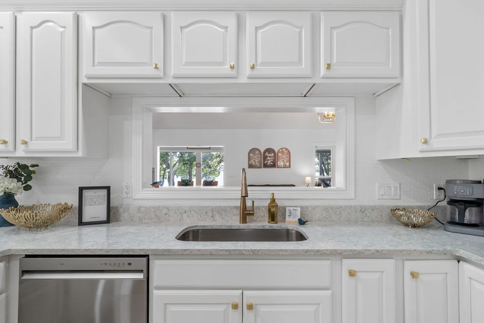 Ample counters and a sleek open window overlooking the yard.