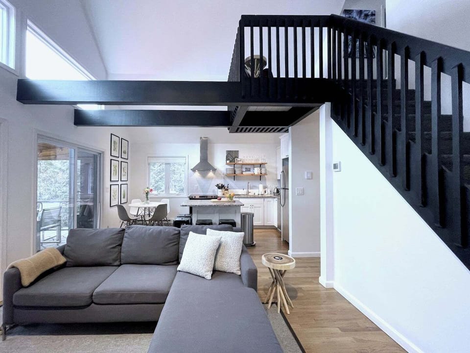 A lofty, open floor plan offers a cozy feel, yet airy and filled with natural light and wonderful views of the lake. 