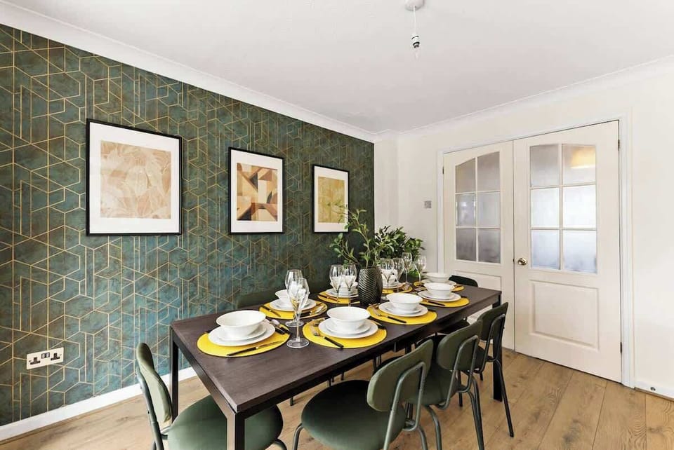 The formal dining space is elegantly styled with a striking feature wall and a table set for six, perfect for entertaining.