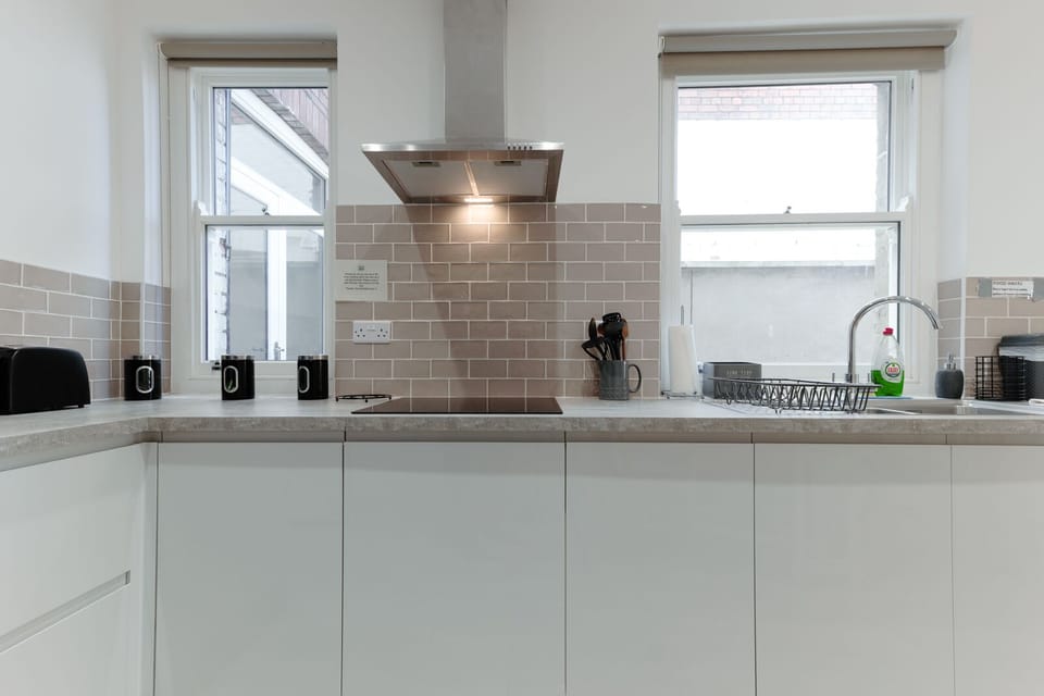 A fully equipped kitchen with a dining table and chairs for group meals