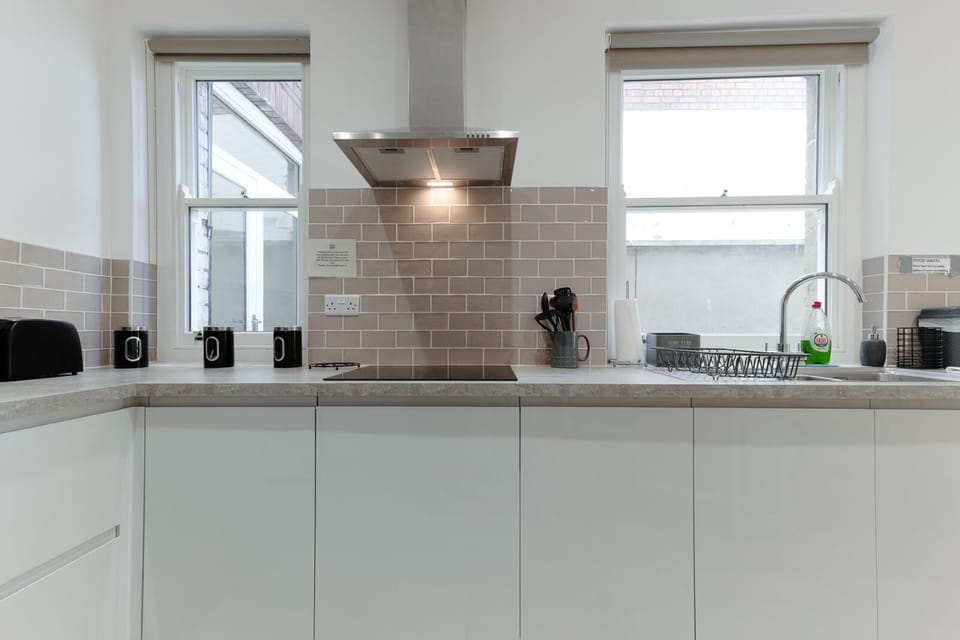 A fully equipped kitchen with a dining table and chairs for group meals
