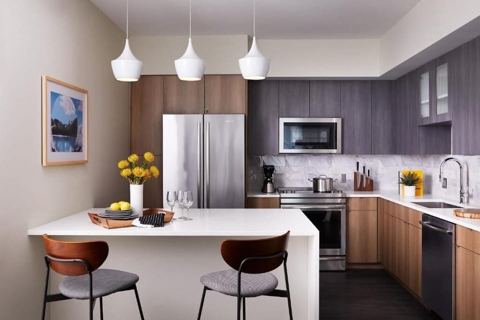 Cook and gather around the sleek island under warm pendant lights.