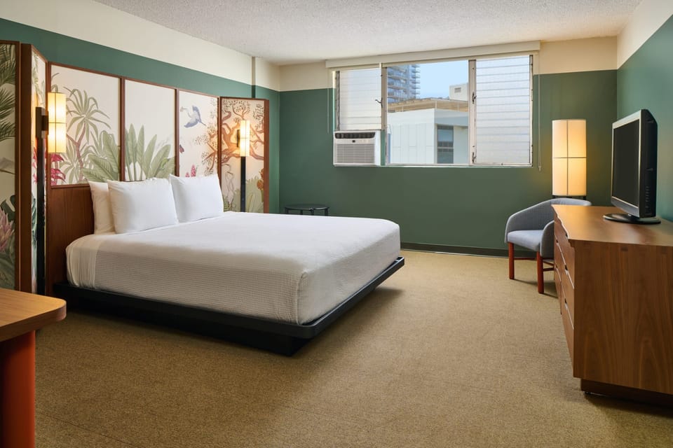 Unwind in a spacious room with calming tropical-inspired design.