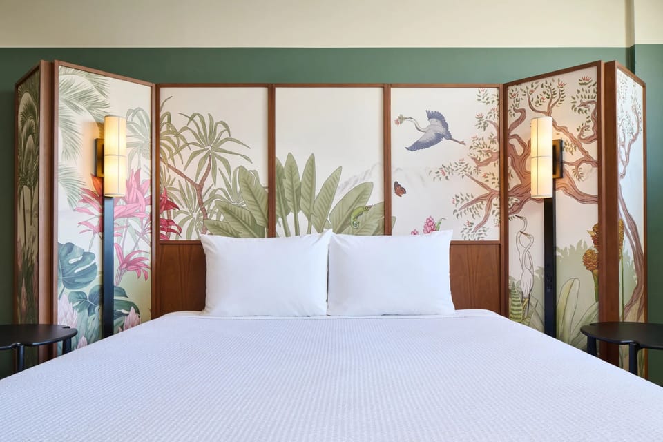 Relax beneath the artful headboard and softly glowing bedside lamps.