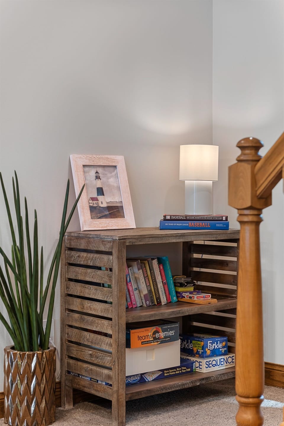 Shelf stocked with board games and books for all ages.