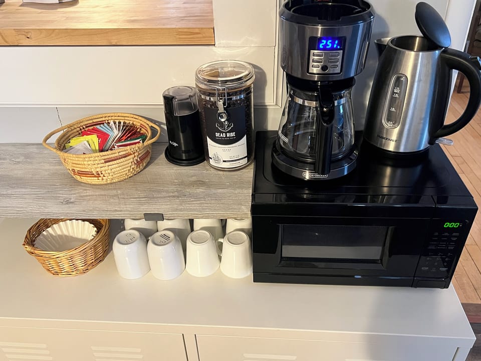 Coffee maker & grinder with locally roasted beans. Tea kettle with assorted teas