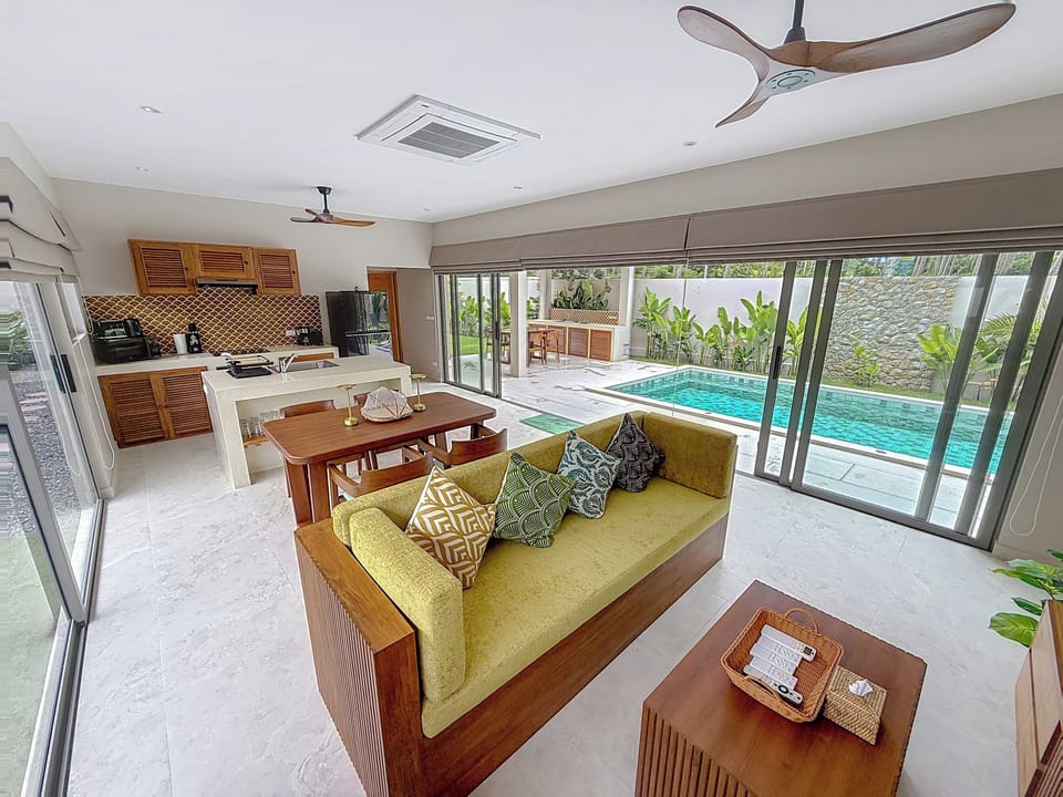 the spacious living room with full-height sliding glass doors to let in light an