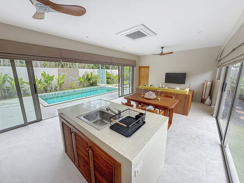 the spacious living room with full-height sliding glass doors to let in light an