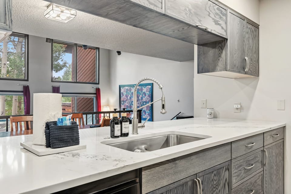 Kitchen: Main floor, drip coffee maker, blender, toaster, cooking utensils, tableware