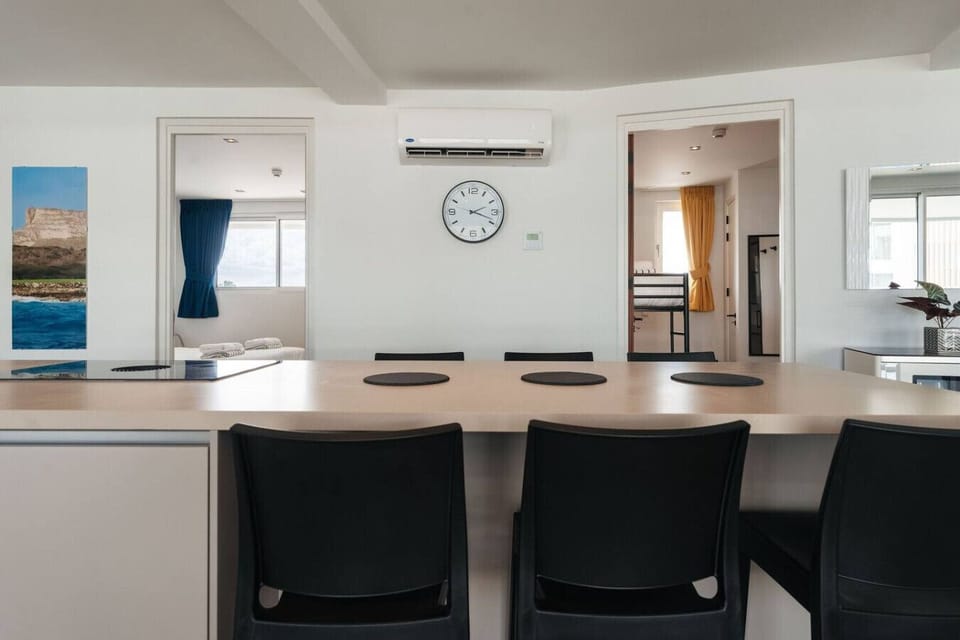 Pull up a stool at the kitchen island and plan your day`s adventures while enjoying a peek into the cozy bedrooms.