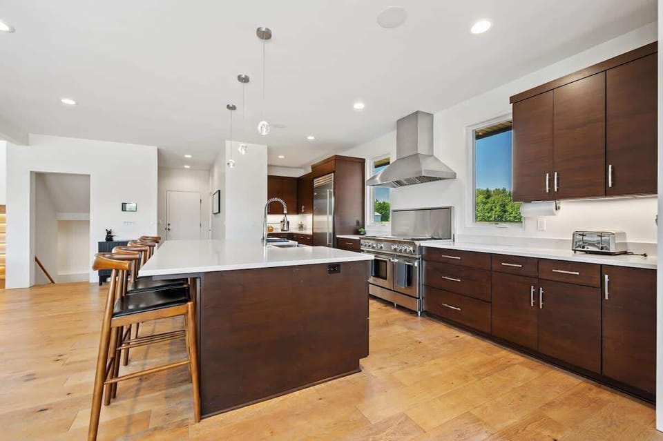 A well-appointed chef’s kitchen awaits, featuring a coffee bar, pantry, and adjacent mudroom with laundry.