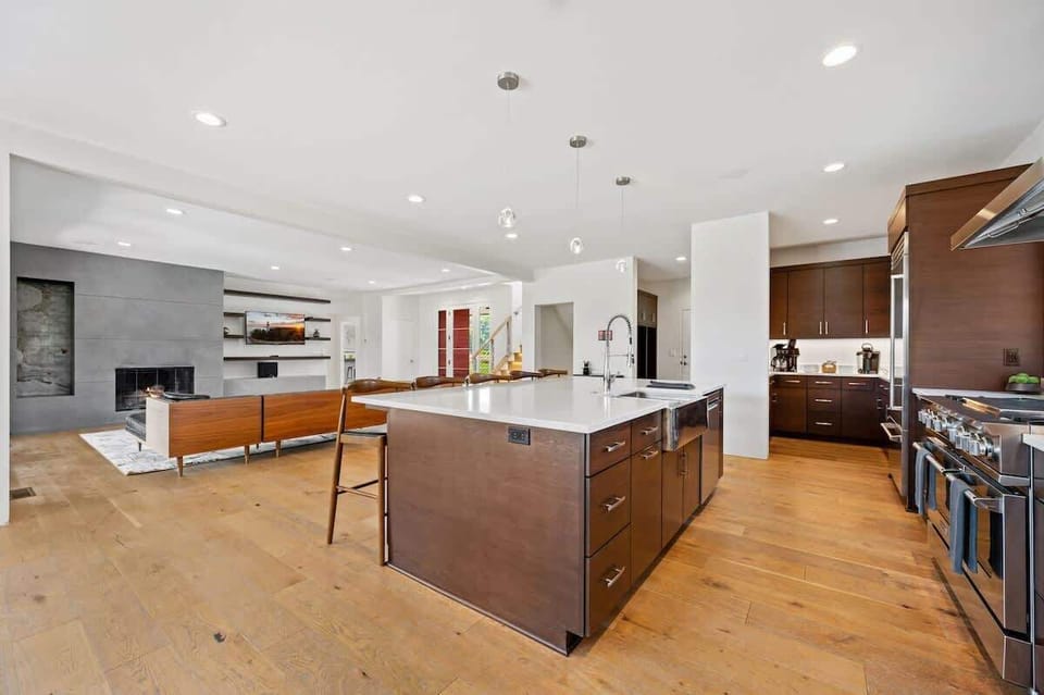 The expansive island provides additional seating and serves as the perfect centerpiece for cooking, entertaining, and connecting.
