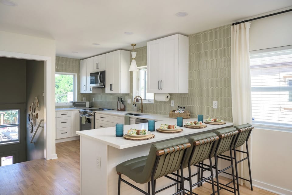 Fully equipped kitchen with large island, bar seating, modern appliances, and everything you need to cook meals or gather with family and friends.