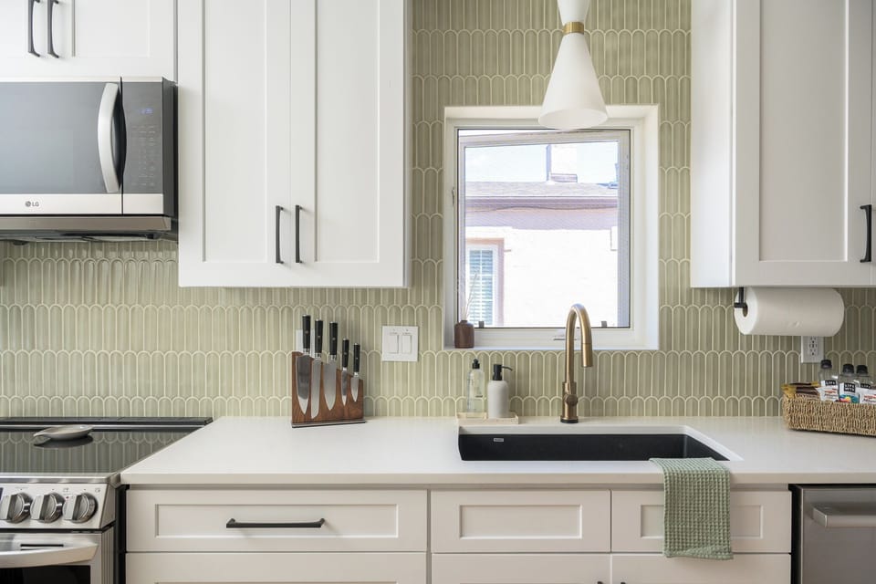 Kitchen prep area with deep sink, sharp knives, and essentials for easy meal prep.