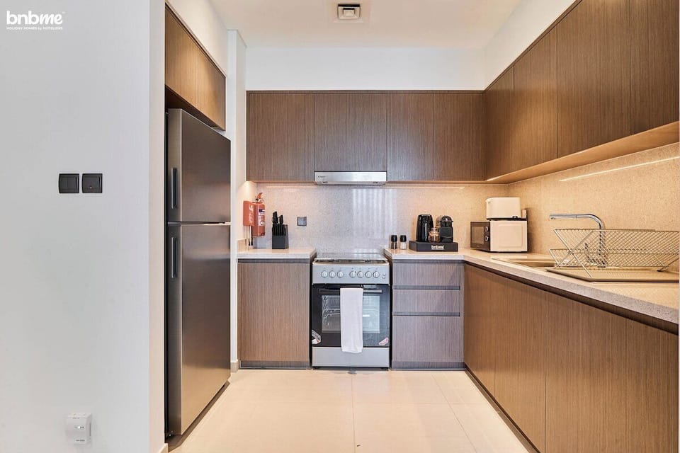 Sleek full kitchen with modern appliances, Nespresso coffee machine, kettle, and all essentials—perfect for short or extended stays in Downtown Dubai.