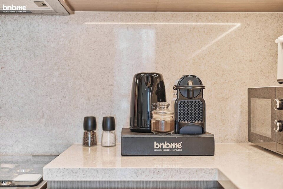 Sleek full kitchen with modern appliances, Nespresso coffee machine, kettle, and all essentials—perfect for short or extended stays in Downtown Dubai.