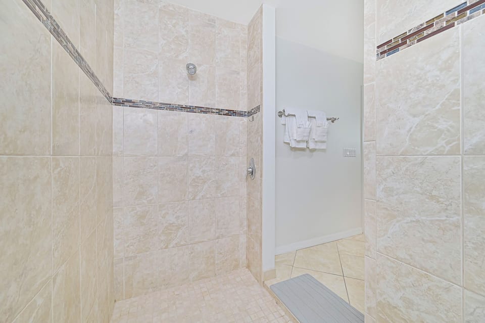 Coral Cove - The en-suite primary bathroom features double sinks, a soaking tub (not jetted), and a large walk-in shower