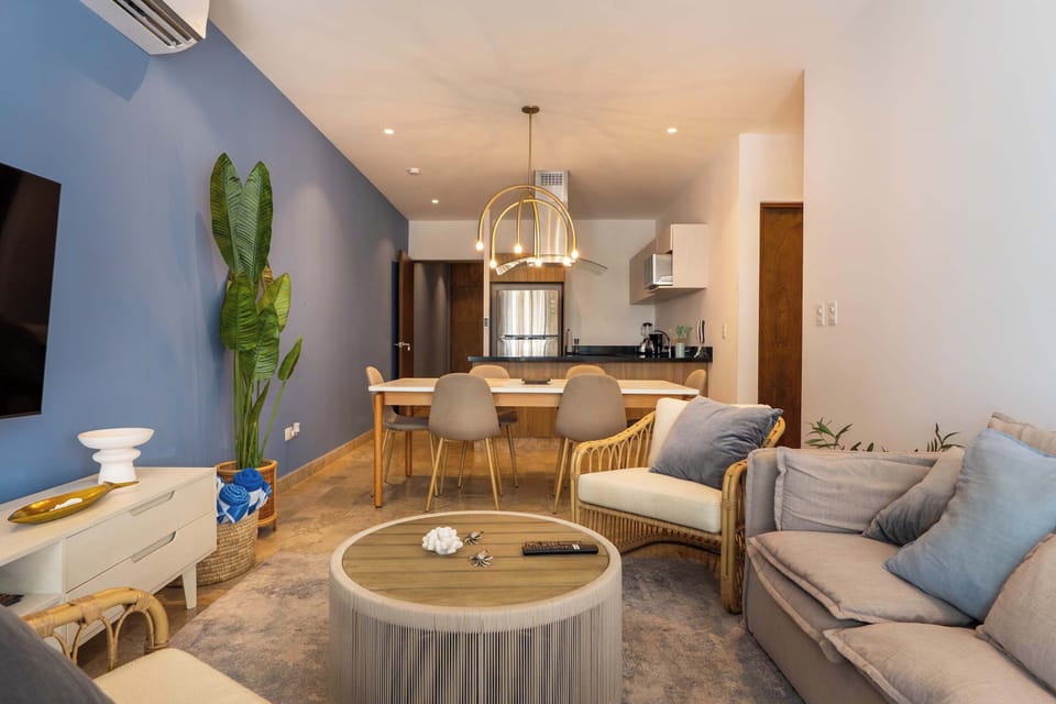 Open-concept living with cozy lounge and integrated modern kitchen.