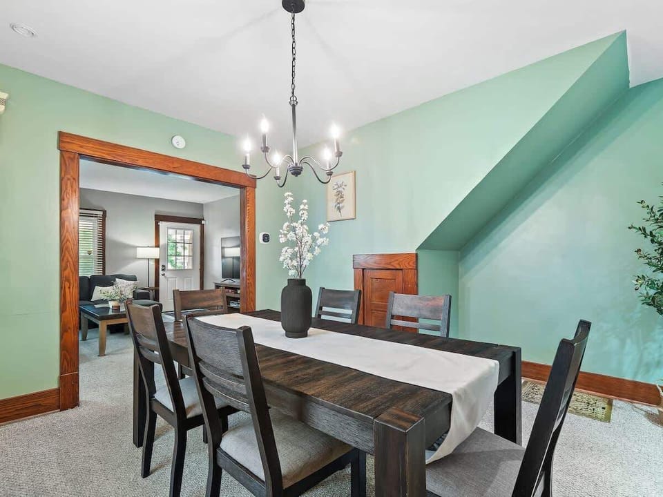 Stylish dining room with seating for six, open to kitchen—great for shared meals ✨