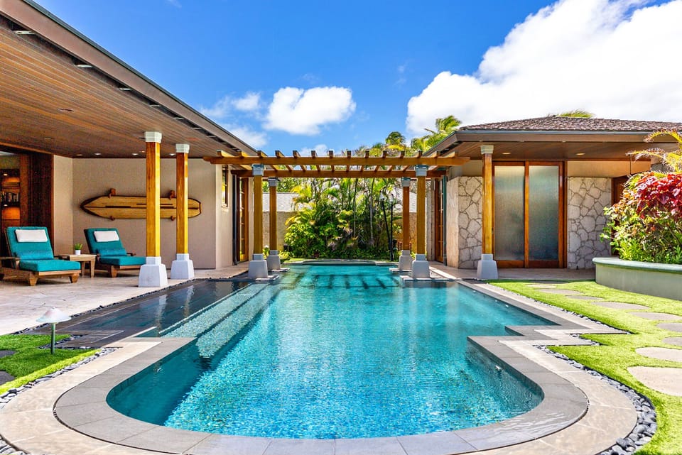 Private pool courtyard framed by tropical gardens.