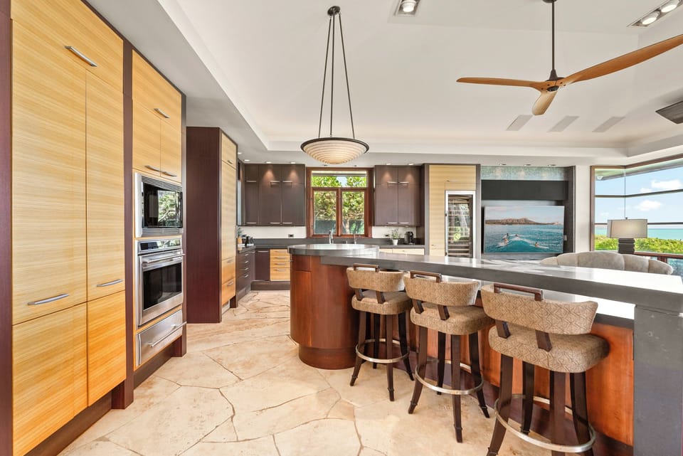 Kitchen with breakfast bar and stainless appliances.
