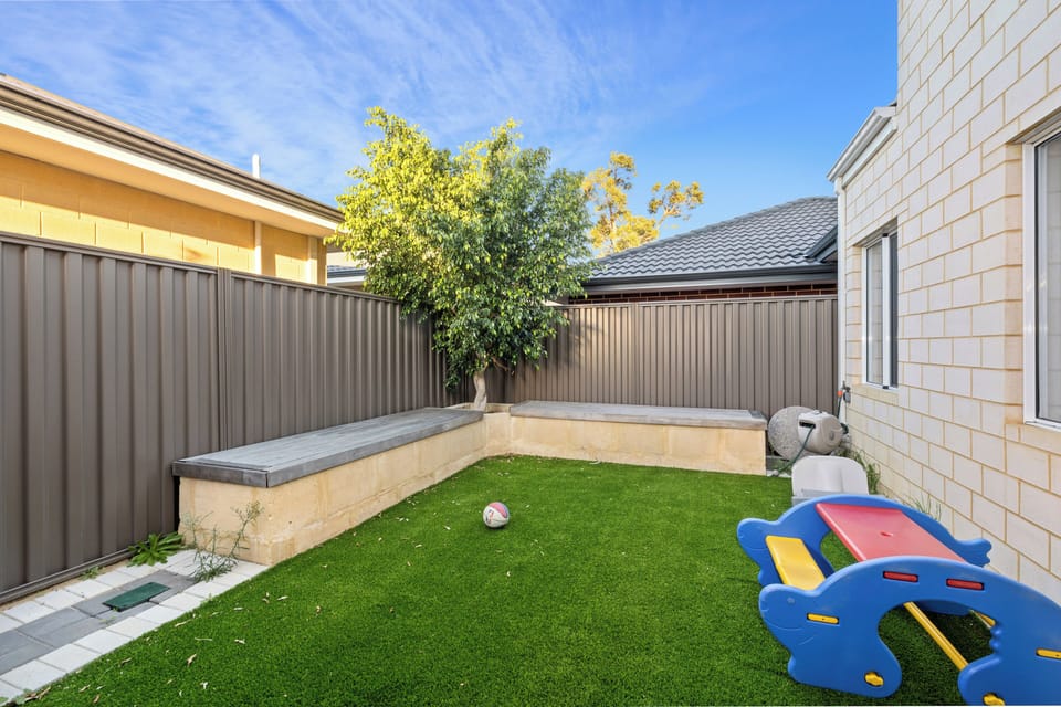 Featuring a small playground and built-in seating, it's the perfect spot for safe outdoor play while you relax and enjoy the fresh air.
