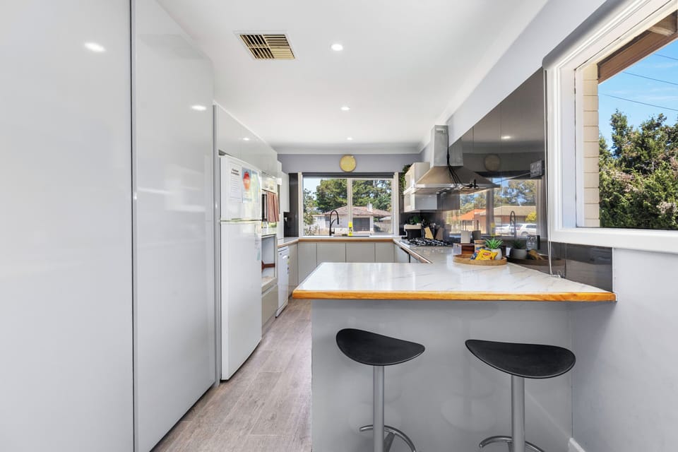 Sleek, fully equipped kitchen featuring a handy breakfast bar for morning coffee or quick meals.