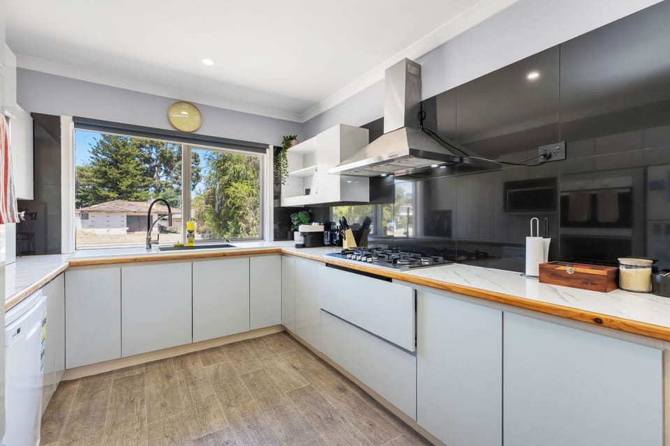 Prepare your meals with ease using our modern gas stovetop and fully equipped kitchen with sleek finishes.
