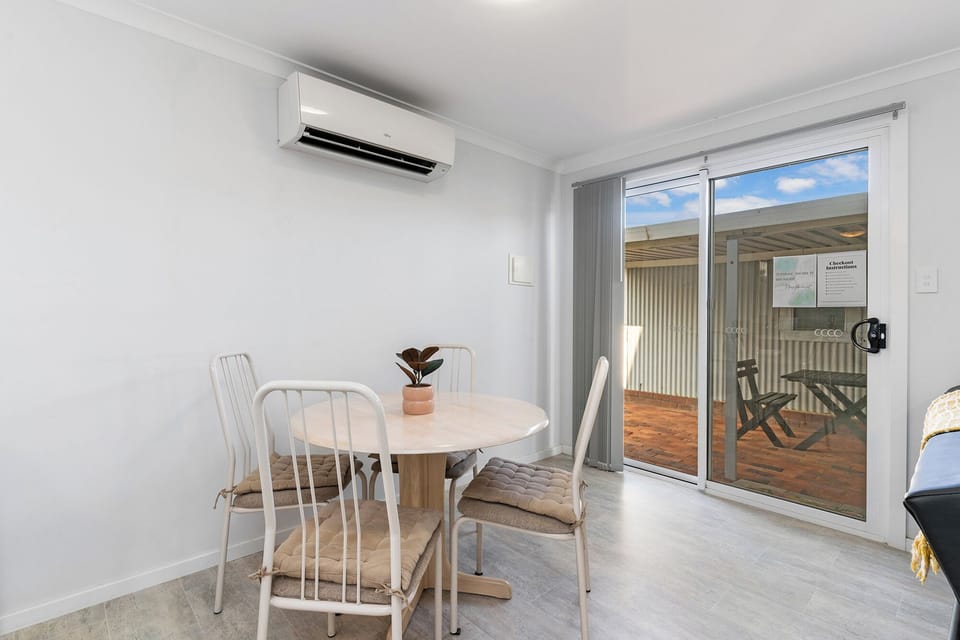 Enjoy a meal or coffee at the air-conditioned dining table for four. It opens directly onto a private patio for seamless indoor/outdoor living.