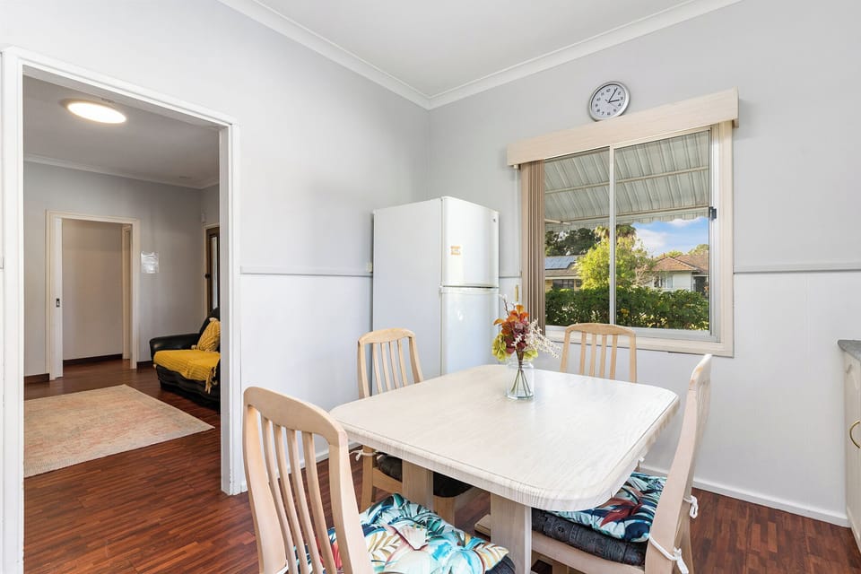 Bright and airy dining area with a simple, clean table setting, ready for your next meal.