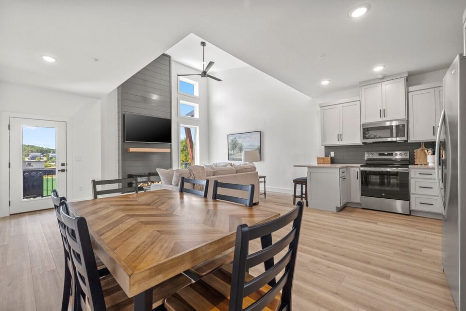 Open-concept kitchen, dining, and living area designed for gathering and entertaining.