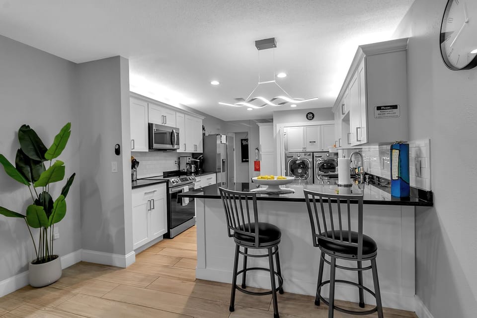 Shared Kitchen With Barstool Seating and Washer/Dryer