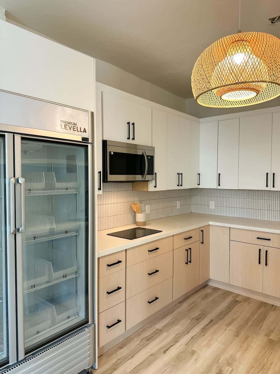 Spacious and modern kitchen featuring sleek cabinetry, ample counter space, and a full-size refrigerator for your convenience